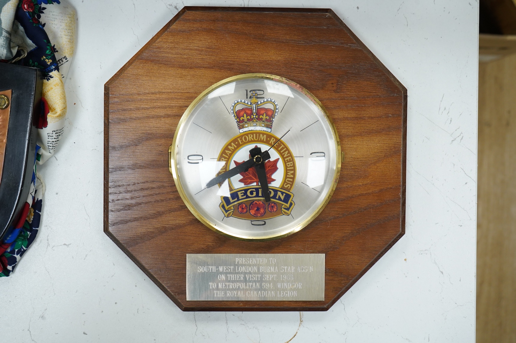 A suitcase of military related items, including; a Manchester Guardian issued early 20th century map of Europe printed on cotton, a First World War trench art match holder the base formed from a cartridge case, two swagg